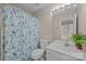 Bathroom featuring vanity, mirror with lighting, commode, and a blue floral shower curtain at 12407 Crowley Ct, Charlotte, NC 28277