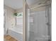 Bathroom with separate tub and shower featuring modern fixtures and natural light at 12407 Crowley Ct, Charlotte, NC 28277