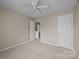 Neutral bedroom featuring carpet, a ceiling fan and access to an en suite bathroom at 12407 Crowley Ct, Charlotte, NC 28277