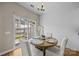 Bright dining area with a sliding glass door to the backyard, hardwood floors, and neutral decor at 12407 Crowley Ct, Charlotte, NC 28277