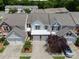Aerial view of a townhome with white siding, double garage, and well-maintained landscaping at 12407 Crowley Ct, Charlotte, NC 28277