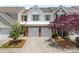 Charming townhome featuring a two-car garage, brick accents, and well-maintained landscaping at 12407 Crowley Ct, Charlotte, NC 28277