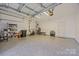 View of a spacious garage with speckled flooring and ample storage and exercise equipment at 12407 Crowley Ct, Charlotte, NC 28277