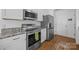 Modern kitchen featuring stainless steel appliances, granite countertops, and ample cabinet space at 12407 Crowley Ct, Charlotte, NC 28277