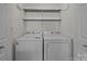 A laundry room featuring a washing machine and dryer set plus overhead storage shelves at 12407 Crowley Ct, Charlotte, NC 28277