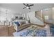 Bright and airy living room with hardwood floors, modern ceiling fan, and staircase at 12407 Crowley Ct, Charlotte, NC 28277