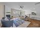 Bright living room with fireplace, ceiling fan, and views from three large windows at 12407 Crowley Ct, Charlotte, NC 28277