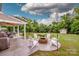 Inviting backyard with a cozy fire pit, seating area, and covered patio for outdoor gatherings at 130 Bay Laurel Dr, Mooresville, NC 28115