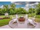 Backyard with a fire pit, Adirondack chairs, and mature trees at 130 Bay Laurel Dr, Mooresville, NC 28115