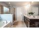 Well-appointed bathroom featuring dual sinks, a soaking tub, and a separate shower at 130 Bay Laurel Dr, Mooresville, NC 28115