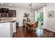 Dining area features a wood table, modern pendant lighting, and views of the backyard at 130 Bay Laurel Dr, Mooresville, NC 28115