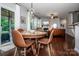 Dining area with hardwood floors, a round table, and view into the living room at 130 Bay Laurel Dr, Mooresville, NC 28115