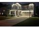 A two-story home is shown at dusk, with light stone and a two-car garage at 130 Bay Laurel Dr, Mooresville, NC 28115