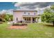 Exterior view of home featuring a large yard, garden, patio, and solar panels at 130 Bay Laurel Dr, Mooresville, NC 28115