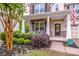 Inviting front porch with a decorative door, comfortable seating, and manicured landscaping at 130 Bay Laurel Dr, Mooresville, NC 28115