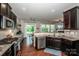 Open-concept kitchen featuring a modern design, stainless steel appliances, and wood flooring at 130 Bay Laurel Dr, Mooresville, NC 28115