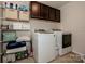 Functional laundry room with washer, dryer, shelving, and storage cabinets at 130 Bay Laurel Dr, Mooresville, NC 28115