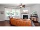 Bright living room with large windows, hardwood floors, fireplace, and modern decor at 130 Bay Laurel Dr, Mooresville, NC 28115
