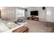 Inviting living room featuring a comfortable sectional sofa and large screen television at 130 Bay Laurel Dr, Mooresville, NC 28115