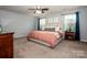 Serene main bedroom boasts natural light, a plush bed, and coordinated furnishings at 130 Bay Laurel Dr, Mooresville, NC 28115