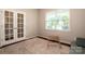 Bright office space with French doors, neutral walls, and a cozy seating area for a tranquil work environment at 130 Bay Laurel Dr, Mooresville, NC 28115