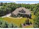 Expansive aerial view of a luxury home with lush landscaping and a sprawling lawn, showcasing its peaceful setting at 14010 Mccord Rd, Huntersville, NC 28078