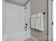 Bathroom with white subway tile surround and tiled floor, featuring black fixtures at 14010 Mccord Rd, Huntersville, NC 28078