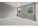 Bedroom with neutral walls, white trim, 2 windows, a ceiling fan and carpeted floors at 14010 Mccord Rd, Huntersville, NC 28078