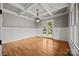 Dining room with hardwood floors, wainscoting, tray ceiling, and glass patio doors at 14010 Mccord Rd, Huntersville, NC 28078