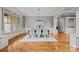 Formal dining room with classic wainscoting and trim, chandelier lighting, and beautiful hardwood floors at 14010 Mccord Rd, Huntersville, NC 28078