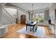 Open dining room features hardwood floors, a modern chandelier, and views of the outdoor scenery at 14010 Mccord Rd, Huntersville, NC 28078
