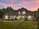 Charming exterior elevation featuring stone accents, manicured landscaping, and a well-maintained lawn at 14010 Mccord Rd, Huntersville, NC 28078