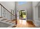 Two-story foyer with hardwood floors, staircase, and arched entry leading to the front yard at 14010 Mccord Rd, Huntersville, NC 28078