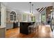 Open kitchen features a center island with seating, stone fireplace, and hardwood floors at 14010 Mccord Rd, Huntersville, NC 28078