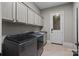 Well-equipped laundry room features a modern washer and dryer set and ample cabinet space at 14010 Mccord Rd, Huntersville, NC 28078