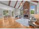 Inviting living room features a stone fireplace, exposed wood beams, and an adjacent dining area at 14010 Mccord Rd, Huntersville, NC 28078