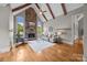 Bright living room featuring a stone fireplace, wood beams, hardwood floors, and neutral decor at 14010 Mccord Rd, Huntersville, NC 28078