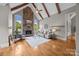 Warm living room featuring a stone fireplace, vaulted ceilings, and hardwood floors, perfect for entertaining at 14010 Mccord Rd, Huntersville, NC 28078