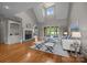 Bright living room features a cozy fireplace, vaulted ceilings, and lots of natural light at 14010 Mccord Rd, Huntersville, NC 28078