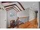 Loft with hardwood floors, wood beams, a window, and wrought iron stair railing at 14010 Mccord Rd, Huntersville, NC 28078