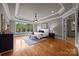 Bright main bedroom with hardwood floors, tray ceiling, and sitting area by a large window at 14010 Mccord Rd, Huntersville, NC 28078