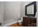 Elegant powder room features a unique vanity and stylish lighting fixtures at 14010 Mccord Rd, Huntersville, NC 28078
