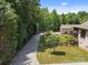 Long driveway leads to the house and separate garage, surrounded by well-maintained landscaping at 14010 Mccord Rd, Huntersville, NC 28078