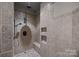Tiled walk-in shower with dual shower heads, built-in niche, and seat at 14010 Mccord Rd, Huntersville, NC 28078