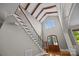 Grand staircase with hardwood steps, wrought iron railings, and a large window at 14010 Mccord Rd, Huntersville, NC 28078