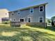 Exterior view of the home's backyard featuring a well-maintained lawn and a wooden deck at 15003 Boudins Ln, Charlotte, NC 28278