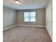 Bright bedroom with a window, neutral walls, and closet at 15003 Boudins Ln, Charlotte, NC 28278