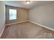 Comfortable bedroom with carpet, a window, and neutral color scheme at 15003 Boudins Ln, Charlotte, NC 28278