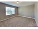 Bedroom with neutral walls, carpet, and a single window at 15003 Boudins Ln, Charlotte, NC 28278