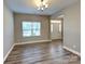Inviting living area featuring wood-look flooring and natural light, highlighting the home's open-concept design at 15003 Boudins Ln, Charlotte, NC 28278